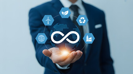 Businessman holding circular economy concept with sustainability icons and global connection