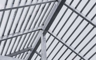 Steel roof structure frame under construction with modern industrial design. Suitable for engineering, architecture, and construction industry visuals. Clear sky background