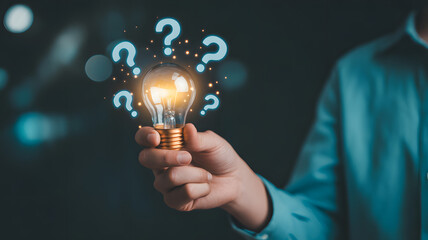 Person holding glowing idea lightbulb surrounded by question marks, symbolizing innovation and problem solving
