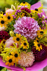 Summer bouquet. Beautiful peach, yellow, purple, magenta, fuchsia and burgundy fresh flower arrangement. Birthday or weddding bouquet made of summer flowers.