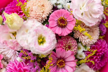 Summer bouquet. Beautiful pink dahlias, lisianthus and zinnias arrangement. Birthday or wedding bouquet made of summer flowers close up.