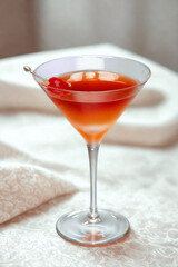 Elegant red cocktail in a martini glass with garnish