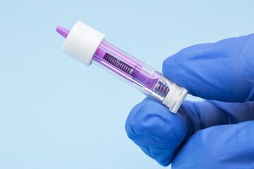 Naklejka premium Disposable safety lancets in doctor hand, used to collect a blood sample from the finger