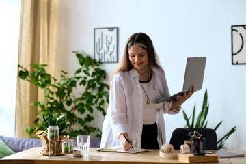 Woman with Waardenburg syndrome thriving while working from home in a cozy space