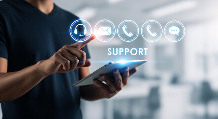 Person touching glowing headset icon above support text on digital tablet for immediate customer assistance