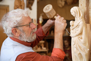 Craftsman carving a statue in Upper Bavaria, Germany