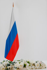 Russia flag and flowers on a white background with space for text.