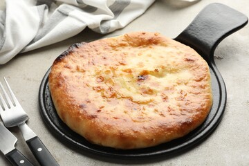 Delicious Megrelian khachapuri served on grey table, closeup