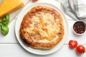 Delicious Megrelian khachapuri and products on white wooden table, flat lay