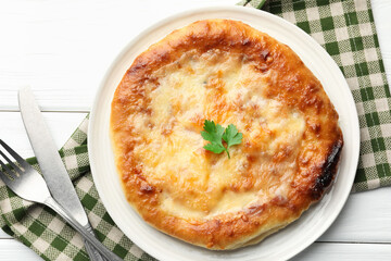 Delicious Megrelian khachapuri served on white wooden table, flat lay
