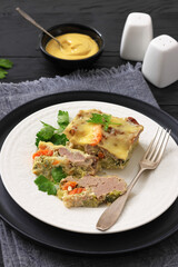Cheesy ground meat vegetables casserole on a plate