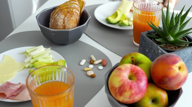 Healthy breakfast table with fruit, avo and dietary supplements and vitamins