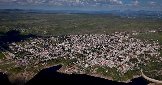 Aerial drone footage on a sunny day capturing the scenic Magic Town of San Jos&eacute; de Gracia, surrounded by mountains and nature in Aguascalientes, Mexico &mdash; a peaceful rural landscape