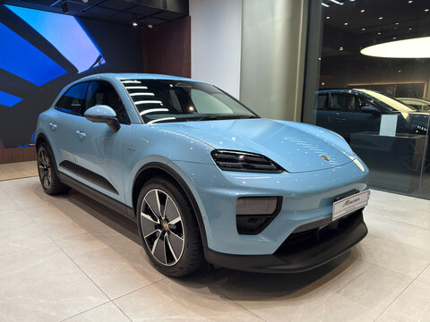 Bangkok, Thailand - July 25, 2025: Blue Porsche Macan Electric SUV on display at Porsche showroom Bangkok