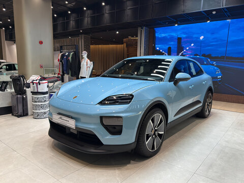 Bangkok, Thailand - July 25, 2025: Blue Porsche Macan Electric displayed at Porsche showroom Bangkok