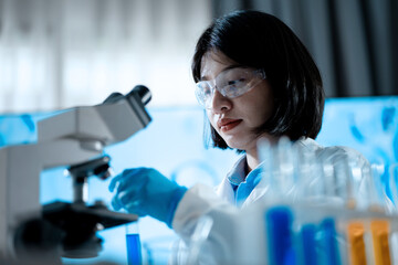 A woman in a lab coat is wearing safety goggles