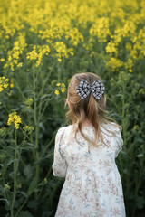 Little girl in a rapseed field.