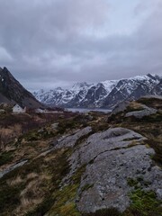 Fototapeta premium Norwegian traditional fishermans village named Sund located on Lofoten islands between the picturesque snow covered mountains and fjords