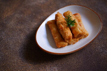 A plate of fried sosis solo in dark background 