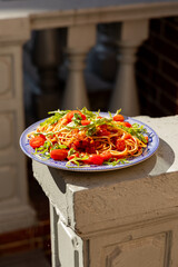A plate of spaghetti pasta photographed in the warm sunlight