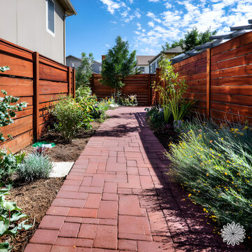 Backyard With Red Pavers As A Walkway