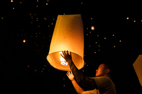 Celebrating freedom and hope with a vibrant sky lantern release in the night sky, creating a magical and unforgettable cultural experience