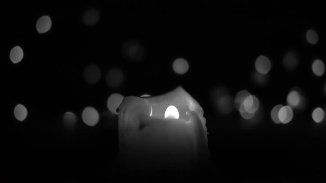 black and white, burning candle, cinematic. romance, relaxation, meditation, special occasions background. mistical lights background and defocused effect 4k