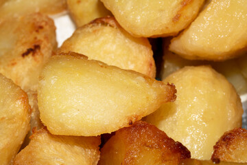 Close up of roasted vegetables crsipy potatoes side dish for Sunday roast dinner