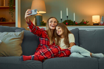 Family Takes Happy Selfie On Sofa During Christmas Holiday At Home Cozy Evening