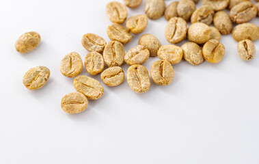 Green Coffee Beans on white background close-up, coffee beans that have been processed and hulled but not yet roasted.