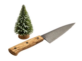 Kitchen knife with textured blade next to miniature frosted pine tree