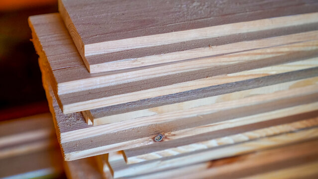 Wooden planks texture background - lumber boards stacked close up 