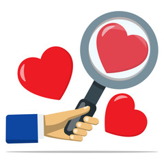 Hand holding magnifying glass with hearts symnol. Concept of searching for love, romantic connections, dating, or relationship exploration.