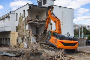 Heavy machinery demolishes building structure during construction project in urban area