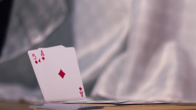 Playing cards falling into table