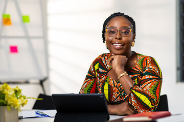 Smiling African woman corporate professional in an office setting, exuding confidence and joy