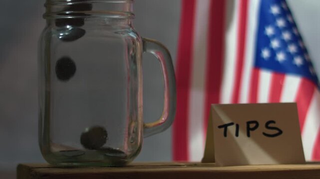 Dropping tips into tip jar 