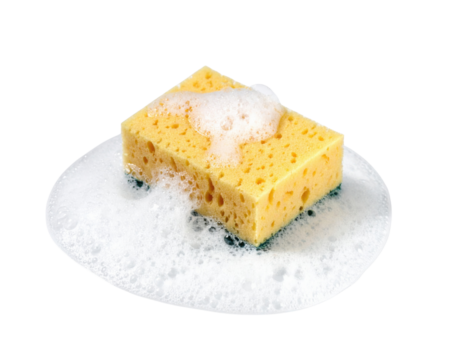 A bright yellow sponge sits in a pool of sudsy bubbles, showcasing its porous texture and cleaning abilities.