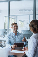 Young manager worker man talking with bank client in office. Business meeting entrepreneur people...