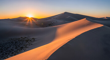 Breathtaking sunset over vast desert dunes, casting long shadows and illuminating sand with golden light, showcasing rugged landscape and serene sky