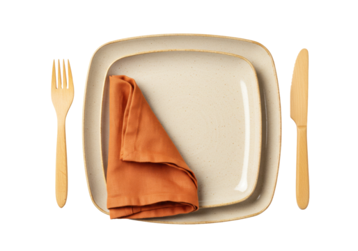 Isolated place setting with square plates, wooden cutlery and orange linen napkin on plate - Powered by Adobe