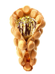 Bubble waffle with ice cream and pistachios topped with chocolate
