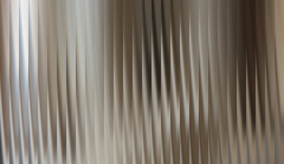 Obraz premium Abstract blurred background with vertical lines in soft, neutral tones. The lines create a sense of movement and texture, perfect for modern designs.