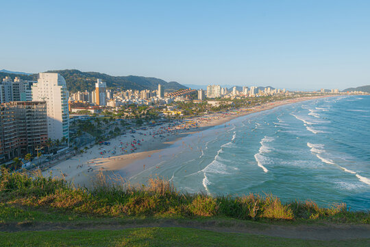Top-down view from Mirante da Campina, showing Enseada Beach in Guaruja. The landscape unites the ocean and the city on a sunny day. Sao Paulo coast, tourism, and tropical travel.