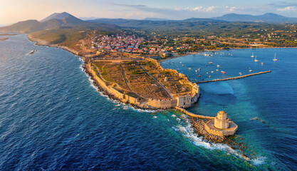 Aerial view of the town of Methoni, Messenia, Peloponnese, Greece, with the old Venetian Castle leading into the sea during summer sunset time