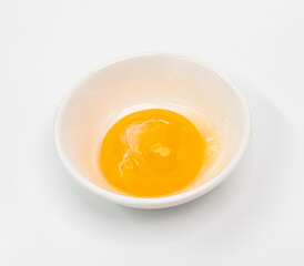 Bright Raw Egg in White Bowl On White Studio Background, Fresh Breakfast Ingredient Photography