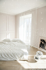 Bright minimalist bedroom with sunlight on white linens.
Wooden herringbone floor and poster add modern style.
Cozy Scandinavian interior radiates calm and natural elegance.
