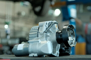 Auto parts. Passenger car.New rear gearbox. Close-up.In the background is the workshop of a service station.