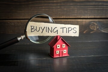 Miniature Red House Displaying Buying Tips for Home Buyers