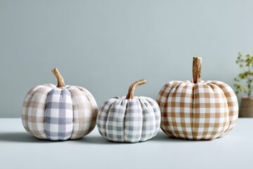 Gingham fabric pumpkins on minimalist background with soft lighting